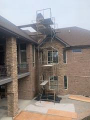 Brick home entryway with exterior masonry around the front door and windows
