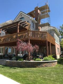 Raised patio or deck area with supporting masonry below